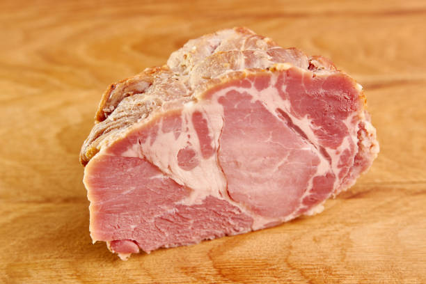istock Ham meat cut into slices on a wooden board. 1499766457