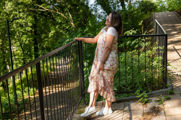 istock Happy woman standing in the forest 1499770945