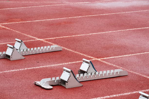 istock Tartan running track for athletic events with starting blocks 1499771096