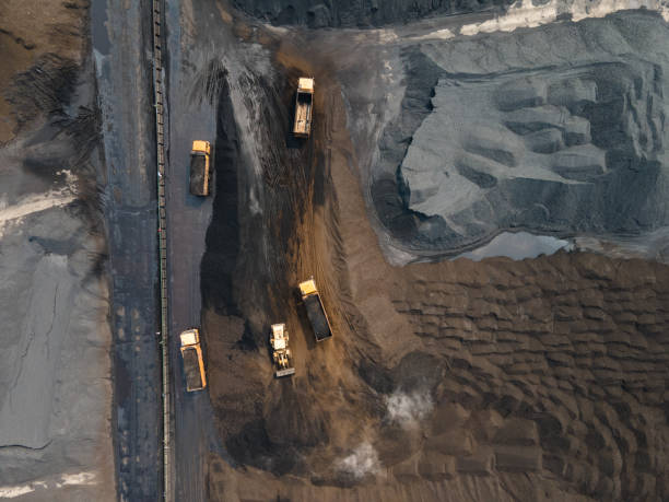 istock Aerial view of truck loading and unloading in large coal mine yard 1499775680