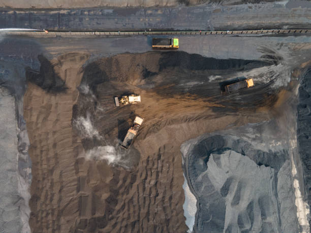 istock Aerial view of truck loading and unloading in large coal mine yard 1499775694