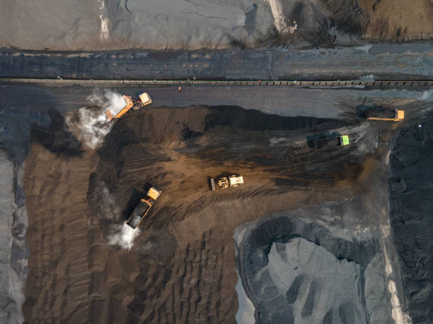 istock Aerial view of truck loading and unloading in large coal mine yard 1499775702