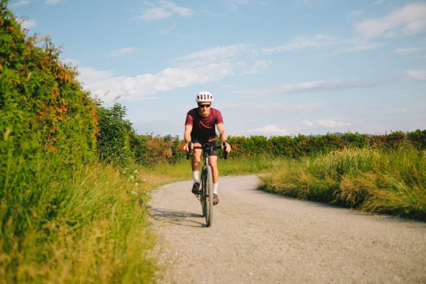 istock Young man rides gravel bicycle on rural track 1499777038