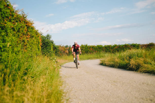 istock Young man rides gravel bicycle on rural track 1499777040