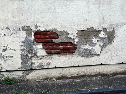 Old rendering and bricks on a wall