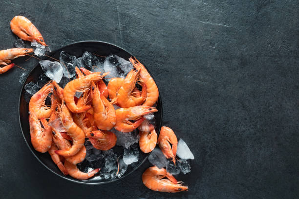 istock Top view shrimps with ice on dark background with copy space 1499781374