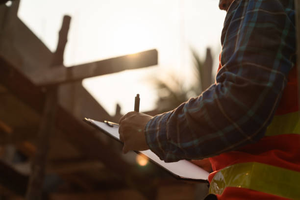 istock inspector or engineer is inspecting construction and quality assurance new house using a checklist. Engineers or architects or contactor work to build the house before handing it over to the homeowner 1499783389