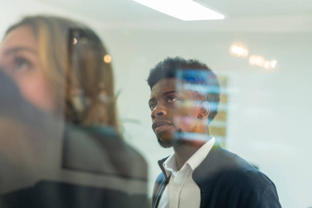 istock Brainstorming in the office while pointing on the whiteboard in the office that is a glass 1499783696