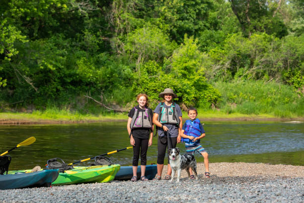 istock Three Kids & Dog Ready to Go Kayaking Down River 1499786558