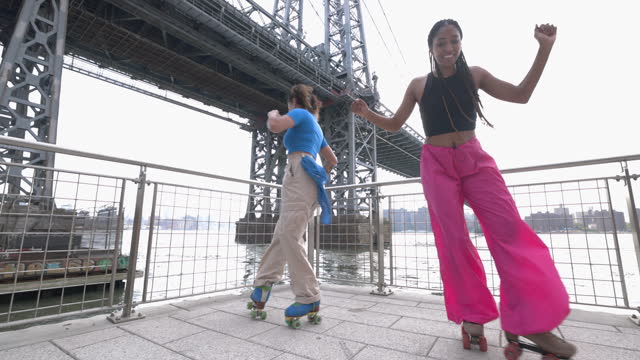 Two friends dancing on roller skates