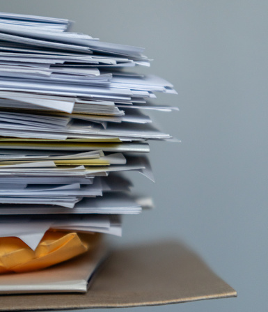 Stack of paperwork on a gray background