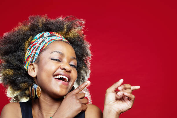 istock Happy young woman points into copy space on red background 1499796075