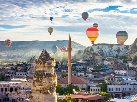 Formation of hot air balloons, early in the morning, in Goreme, Cappadocia, Turkey, at sunrise. Cappadocia is a popular tourist destination.