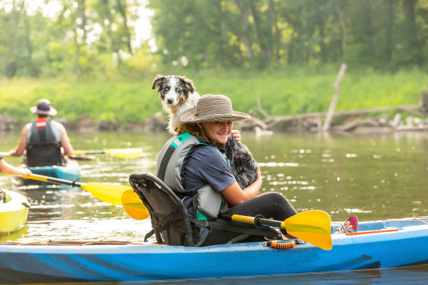 istock Girl & Dog Kayaking Down Rum River in Summer 1499799659