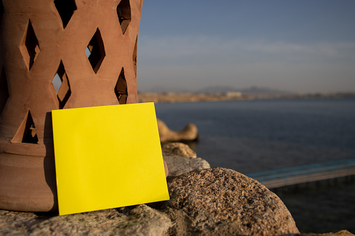 yellow square paper note and tropical blue sea with empty free space for template or blank copy area