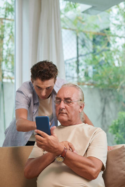 istock Helping Grandfather with Mobile App 1499800091