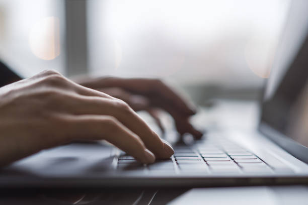 istock Against a blurred office background, the image captures a woman's hands typing on a sleek laptop keyboard 1499801869