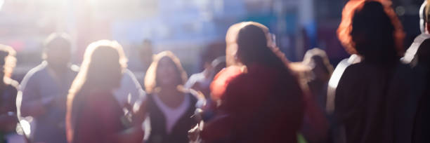 Bordeaux, France, October 1, 2018 : Blurred background people walking on street with sun flare