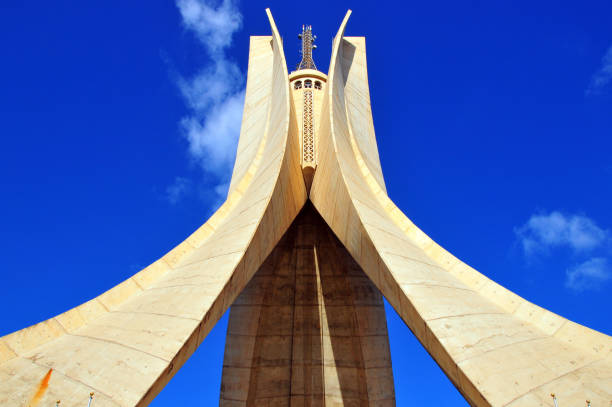 Algiers, Algeria: Monument of the Martyrs of the Algerian War ('مقام الشهيد') - completed in 1982 and representing three palm leaves over the eternal flame - designed by Marian Konieczny and the Fine Art Institute of Algiers, under the leadership of the painter Bashir Yelles - underground, under the monument, is the National Museum of El Mujahid ('Musée National du Moudjahid'), dedicated to the struggle against the European presence - El Madania municipality, Sidi M'Hamed district.