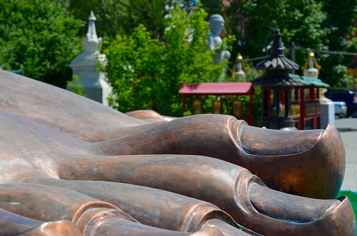 Detail of a large bronze foot in a foreground of a statue at the very beginning of construction - Maitreya’s feet at the Dashichoiling monastery in Ulaanbaatar, Mongolia.
