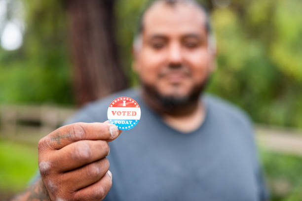 istock Disabled Hispanic Veteran Working with I Voted Sticker 1499810792