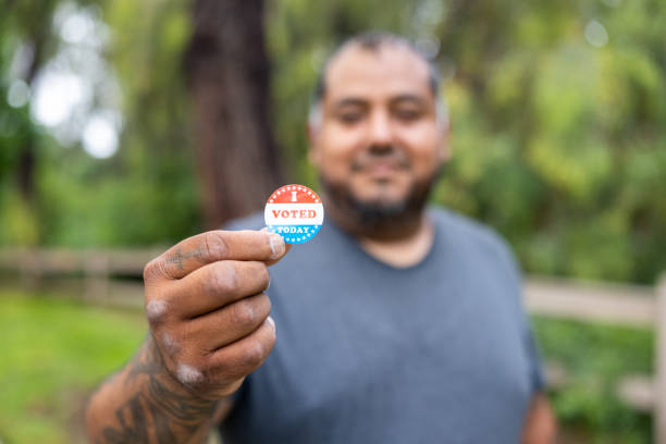 istock Disabled Hispanic Veteran Working with I Voted Sticker 1499810984