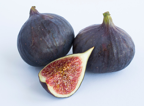Ripe blue figs on the white background. Close-up. Isolated.