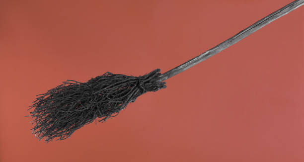 istock old halloween broom on orange background 1499811107