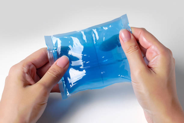 istock Hands holding blue color cold gel pack on white background 1499812609