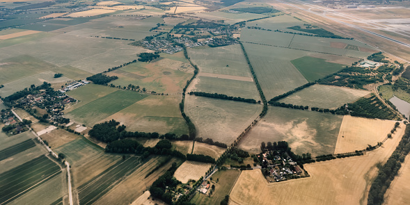 Aerial photography, view on Schönefeld. Brandenburg, Berlin from airplane through the window. Landscape with city and agriculture field from the high point. Traveling concept photo from air.