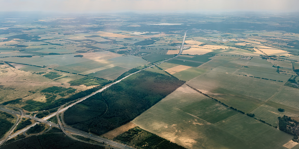 Aerial photography, view on Schönefeld. Brandenburg, Berlin from airplane through the window. Landscape with city and agriculture field from the high point. Traveling concept photo from air.