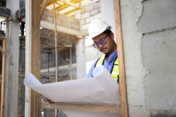 istock Construction engineers  wear reflection green vest work on site   by following up with the planned design.building contractor check the work against the construction 1499816820