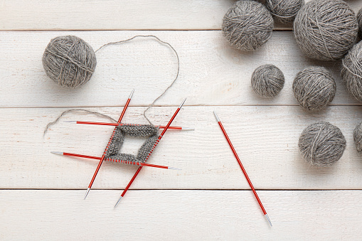 The process of knitting in the circle on double-sided knitting needles, balls of yarn.