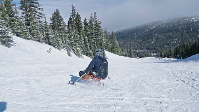 Adaptive athlete using a sit-ski