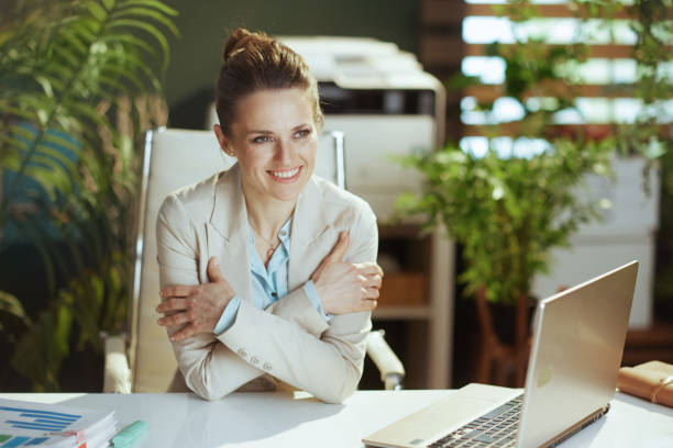 istock happy woman worker in green office hugging herself 1499824534