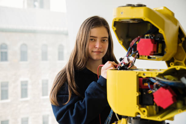 istock Gender fluid college student in robotics classroom. 1499824925