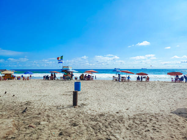 istock beach with people and umbrellas 1499826176
