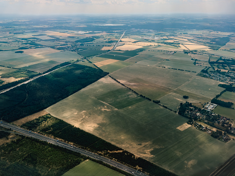 Aerial photography, view on Schönefeld. Brandenburg, Berlin from airplane through the window. Landscape with city and agriculture field from the high point. Traveling concept photo from air.