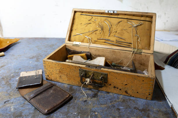 istock Old wooden toolbox from an upholsterer with needles and various craft tools, used for work on the go, traditional craftmanship, copy space, selected focus 1499830995