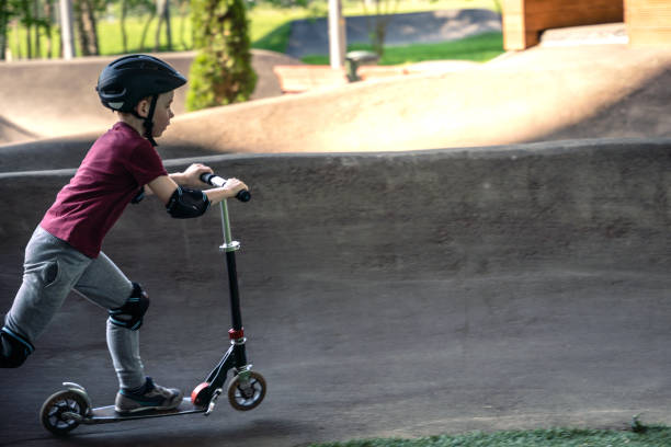 istock Boy riding push scooter at the track 1499831173