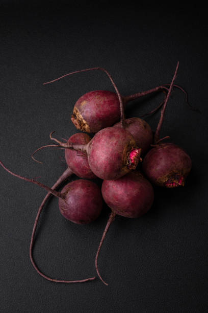 Fresh raw beetroot in the form of tubers on a textured concrete background