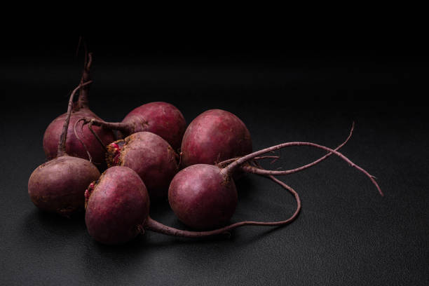 Fresh raw beetroot in the form of tubers on a textured concrete background