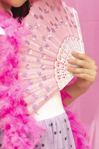 istock A girl's hand with a pink fan 1499833589