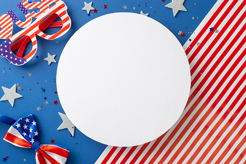 USA-themed festive scene. Overhead shot reveals artistry of party eyewear, bow-tie, shimmering stars, glistening confetti, on American flag background with empty circle, perfect for text or advert