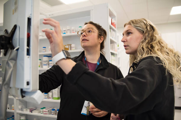 College student with professor in pharmacy studies.