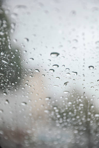 istock Raindrops gracefully dance on a window pane, reflecting a moody rainy day. Symbolizing introspection, renewal, and nature's serene beauty 1499836881