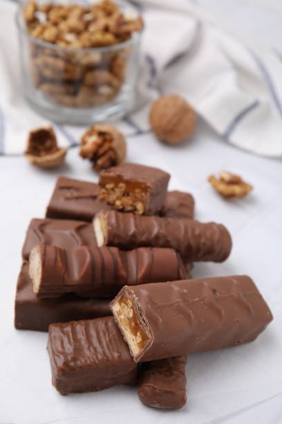 istock Pieces of different tasty chocolate bars on white table 1499837846