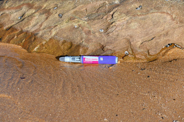 Used semaglutide injecting pen Used semaglutide pen discarded at the beach wegovy stock pictures, royalty-free photos & images