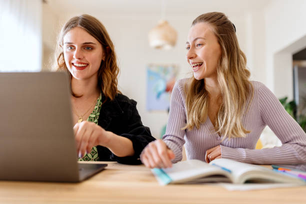 istock Smiling friends studying at home 1499842813