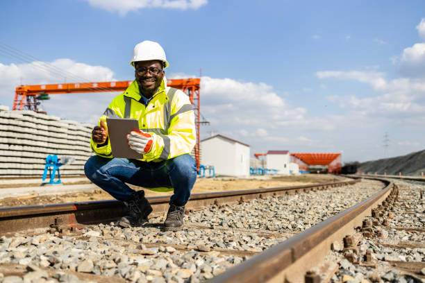 istock Railroad engineer inspecting quality of train tracks and fast railway construction. 1499844351
